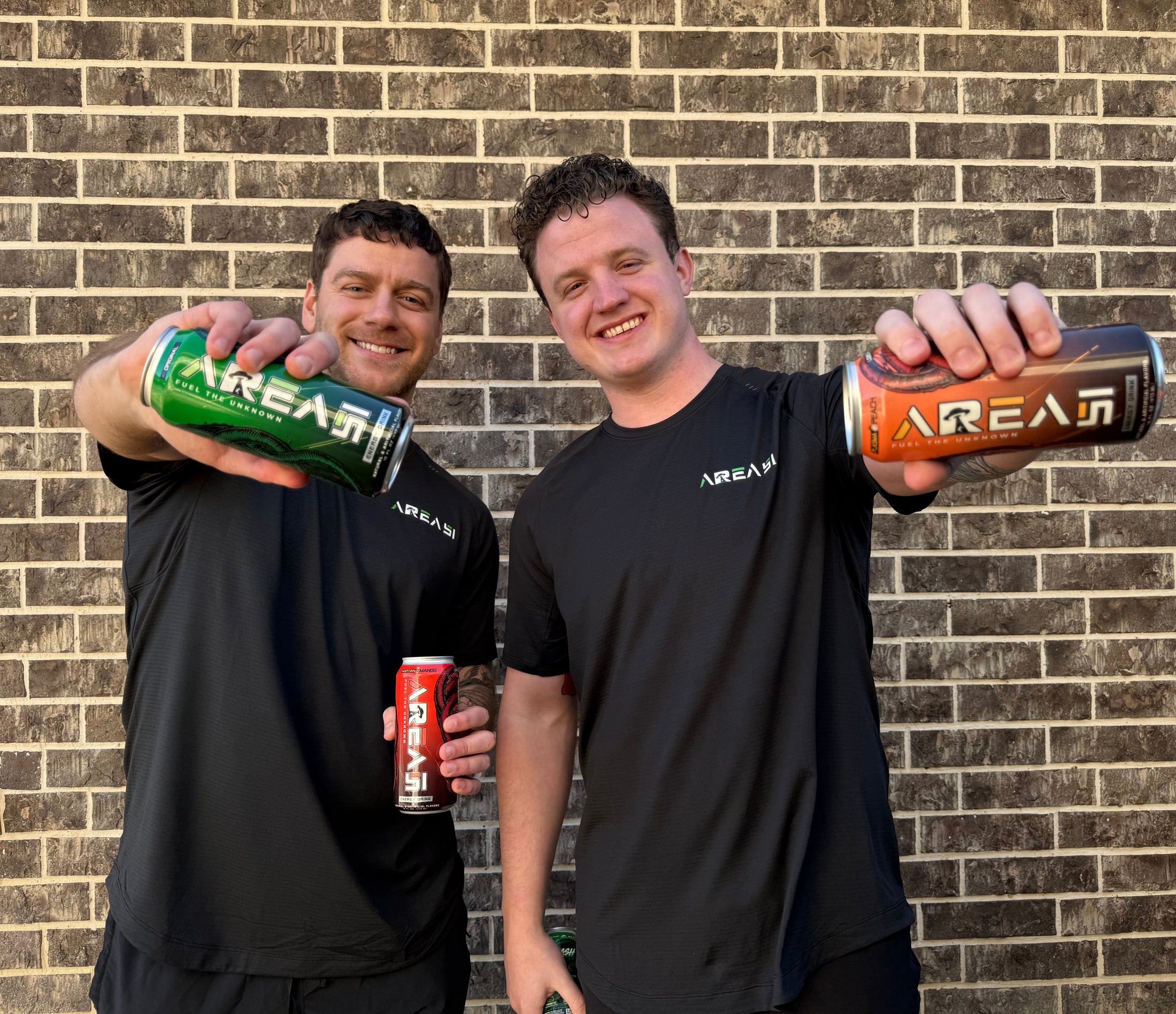 Area 51 founders holding Original and Plasma Peach cans